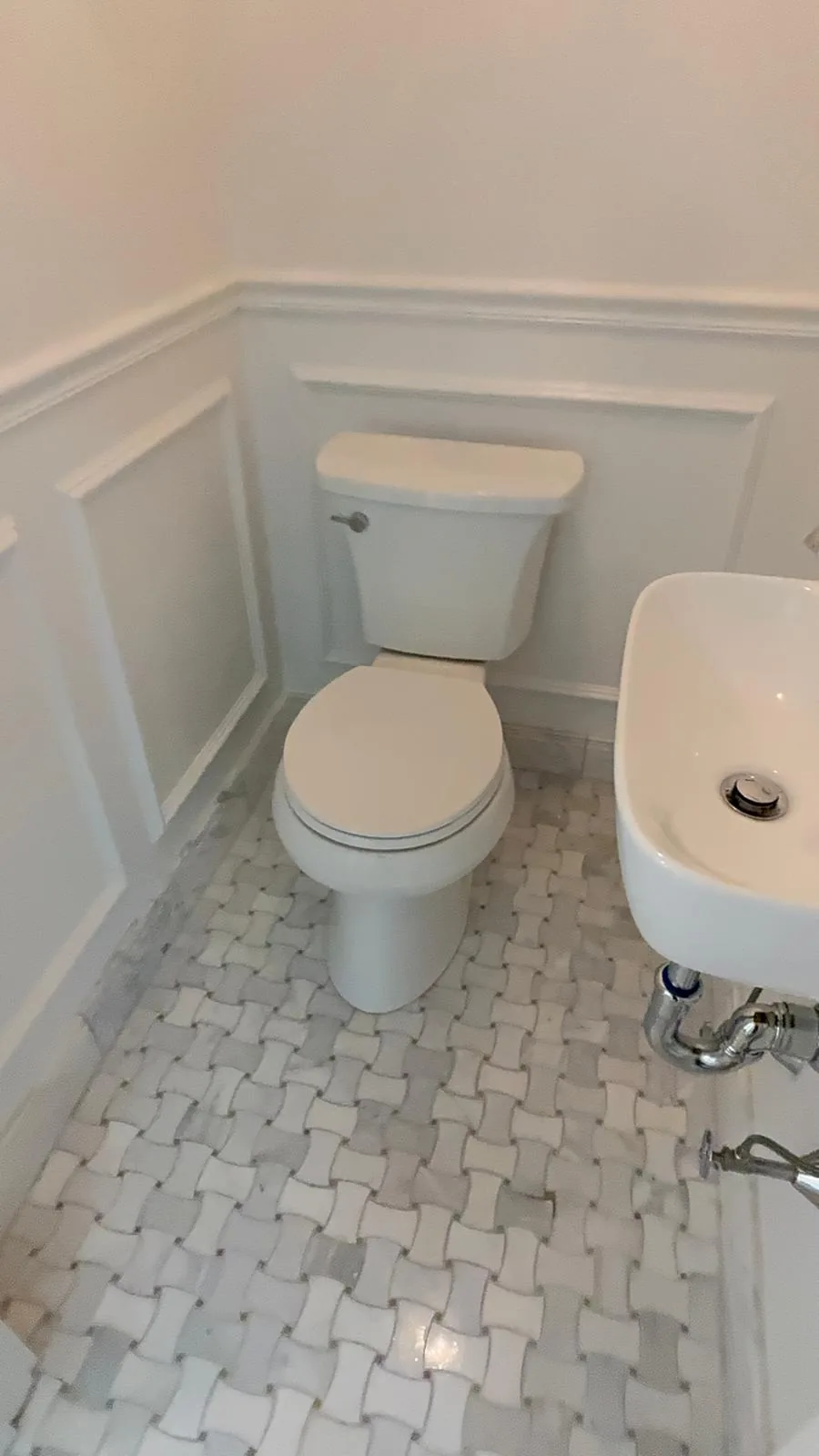 CRC bathroom with marble mosaic floor and decorative wall trim