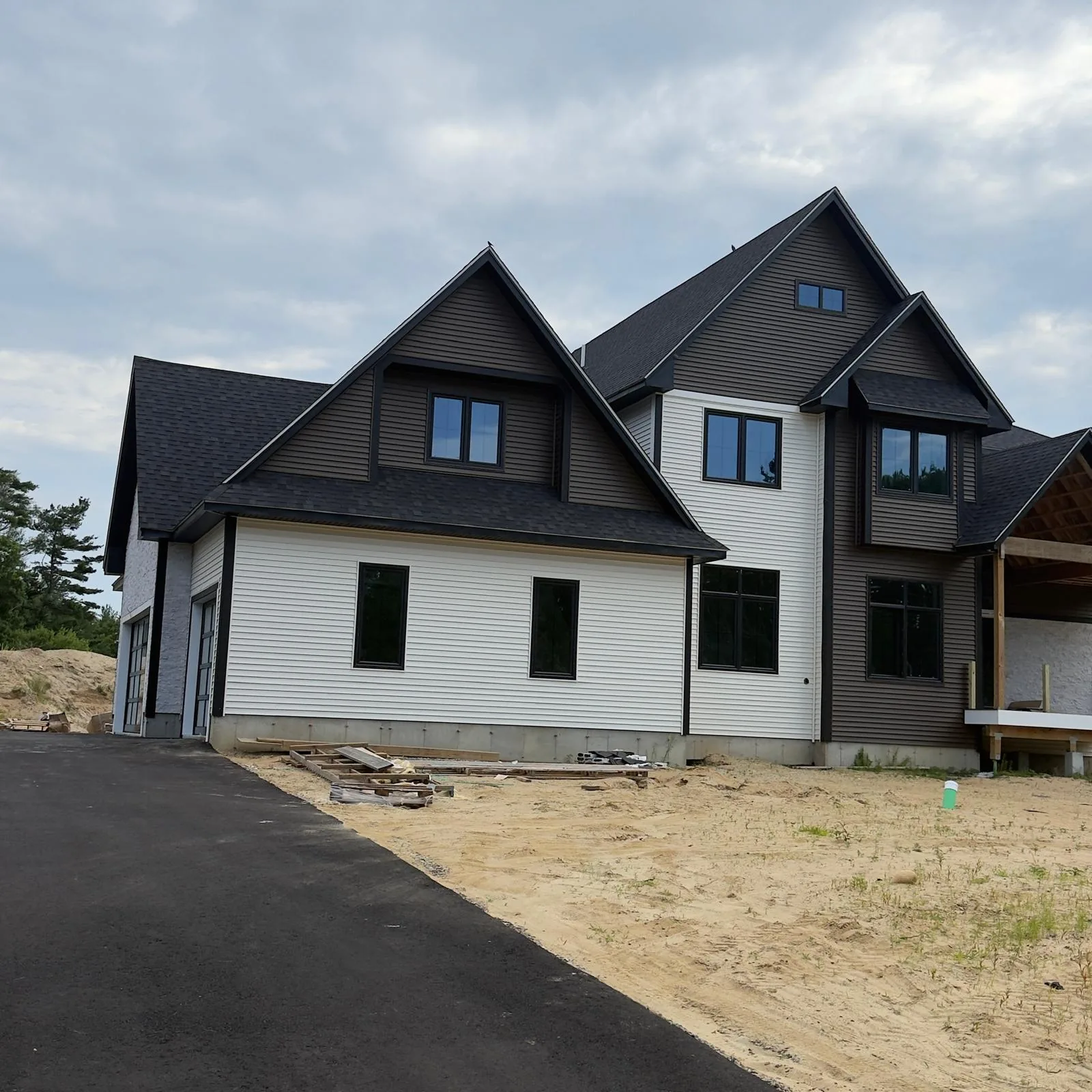Exterior of a client home with contrasting siding and dark gables